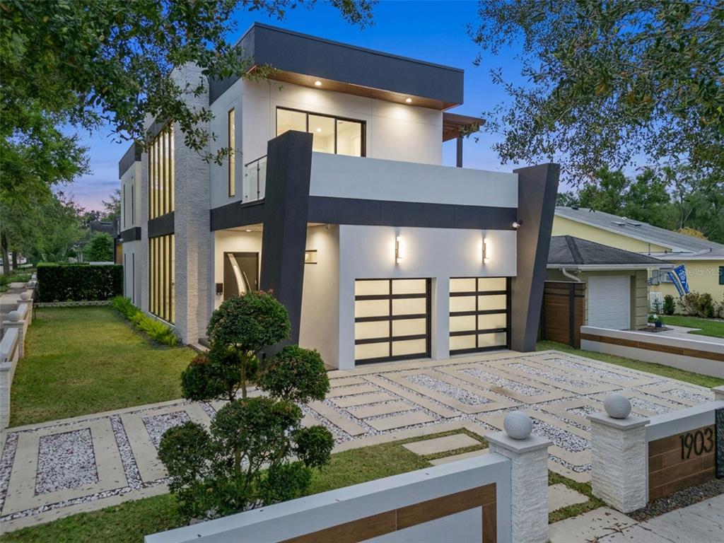 A modern two-story house features a white facade, dark trim, and a two-car garage — 1903 N PARK AVENUE, WINTER PARK, FL