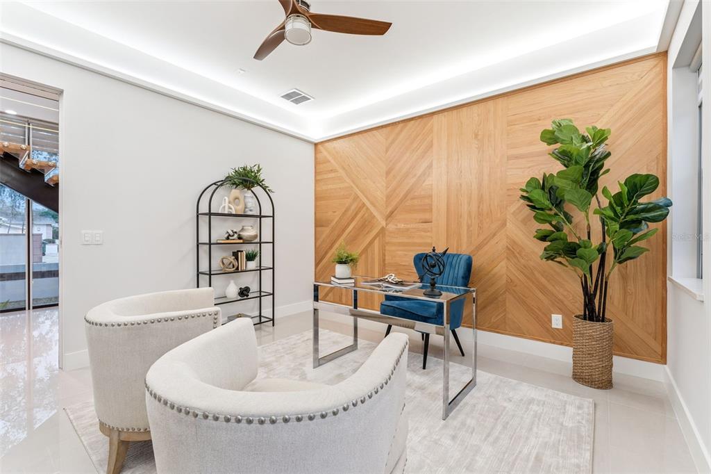 A home office features a wood-paneled accent wall, a glass desk, and two cream armchairs — 1903 N PARK AVENUE, WINTER PARK, FL