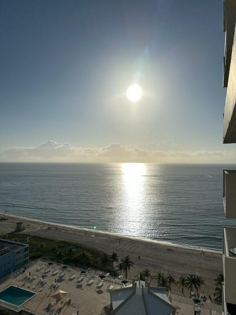 An elevated view of a beach, ocean, and sunlit horizon from a building balcony — 111 Briny Avenue # 2103, Pompano Beach FL 33062, POMPANO BEACH, FL