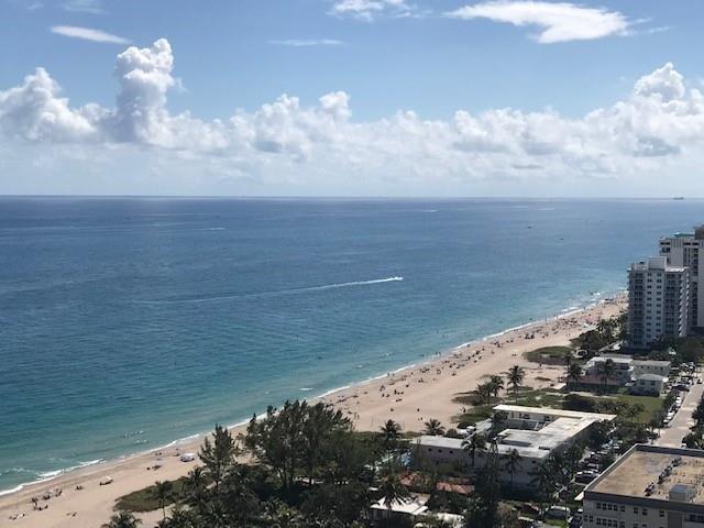 An elevated view of a sandy beach, ocean, and coastal buildings under a blue sky — 111 Briny Avenue # 2103, Pompano Beach FL 33062, POMPANO BEACH, FL