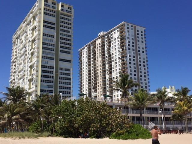 Two tall residential towers stand behind a sandy beach with palm trees and green bushes — 111 Briny Avenue # 2103, Pompano Beach FL 33062, POMPANO BEACH, FL