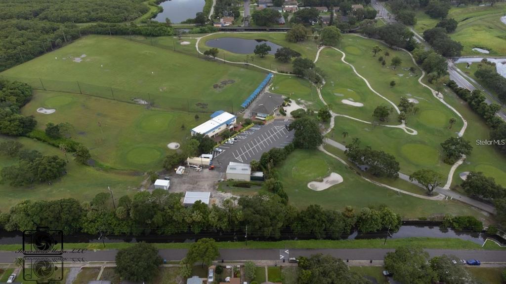 An aerial view shows a golf course with a driving range, clubhouse, and parking lot — 26TH AVENUE S, ST PETERSBURG, FL