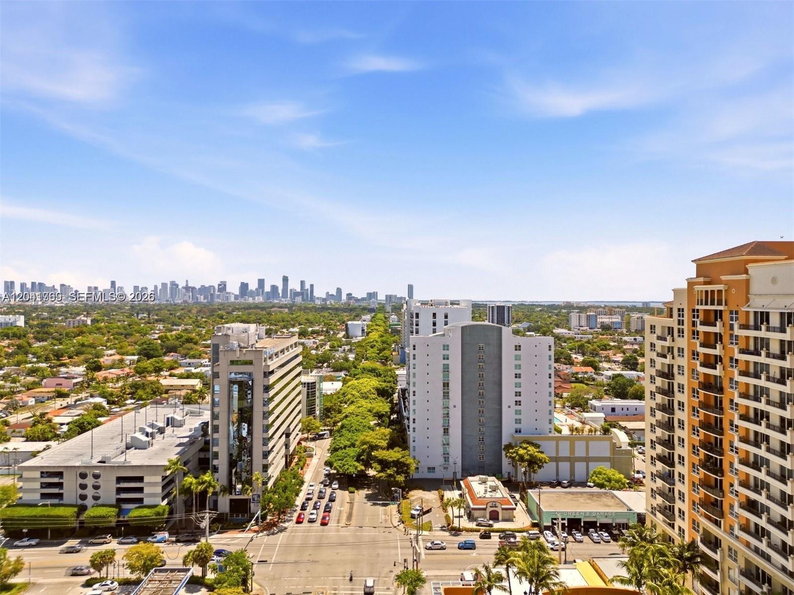 An elevated view shows a city street lined with trees, buildings, and a distant skyline — 3180 SW 22nd Ter, Miami FL 33145, MIAMI, FL