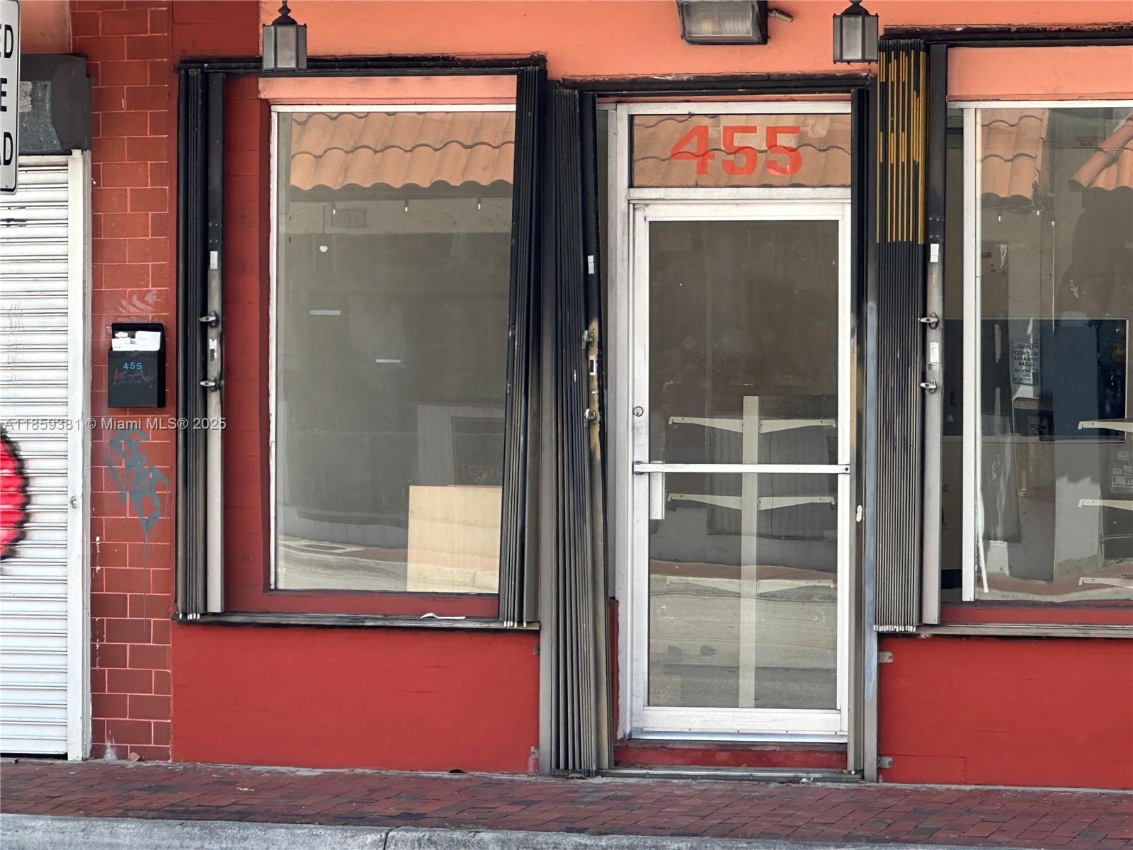 The exterior of a commercial storefront features a glass door, large windows, and red brick — 455 SW 17th Ave, Miami FL 33135, MIAMI, FL