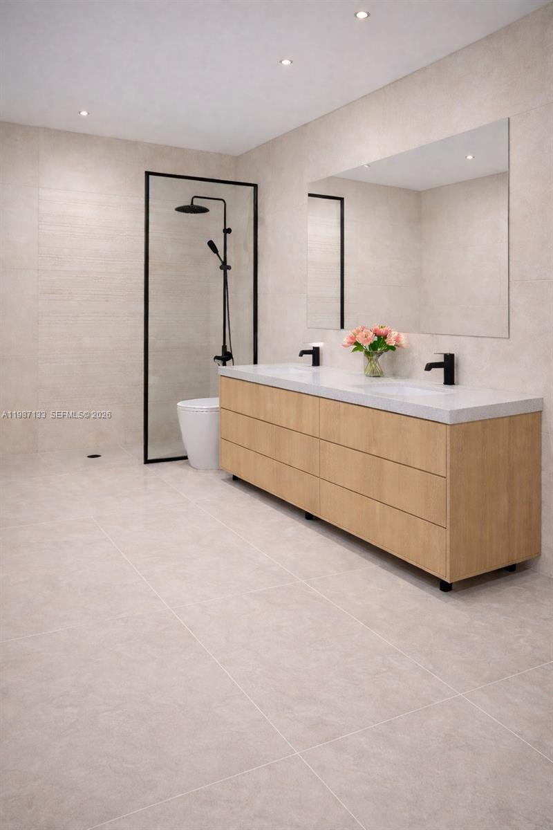 A modern bathroom features a light wood double vanity, a large mirror, and a glass-enclosed shower — 7860 NE Bayshore Ct # 2D, Miami FL 33138, MIAMI, FL