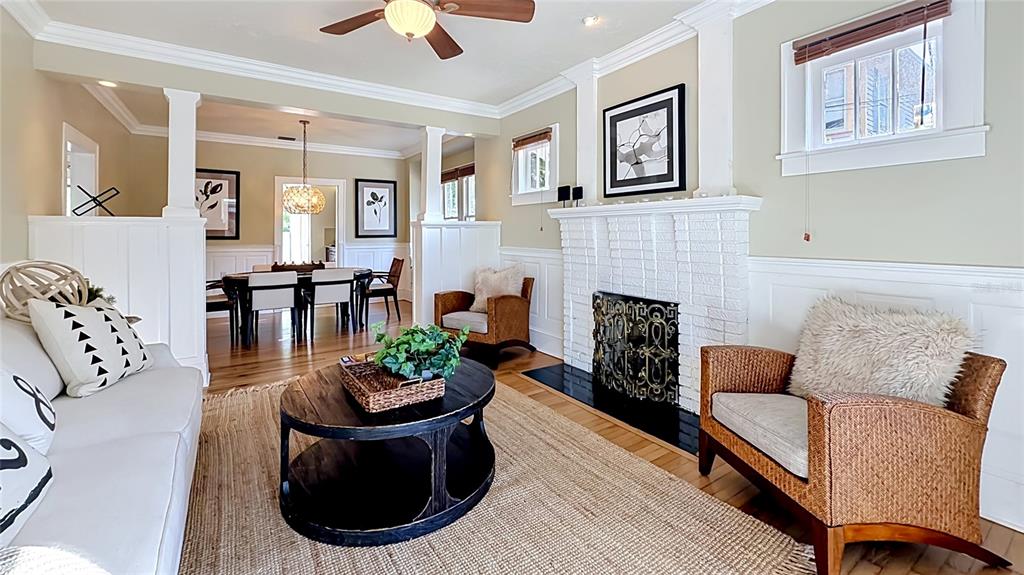 A living room features a white brick fireplace, wicker armchairs, and a round coffee table — 1620 PARK LAKE STREET, ORLANDO, FL