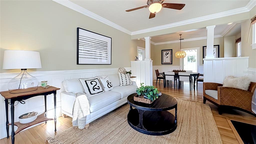 A living room features a white sofa, a round black coffee table, and hardwood floors — 1620 PARK LAKE STREET, ORLANDO, FL