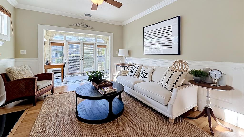 A living room features a white sofa, a round coffee table, and a wicker chair — 1620 PARK LAKE STREET, ORLANDO, FL