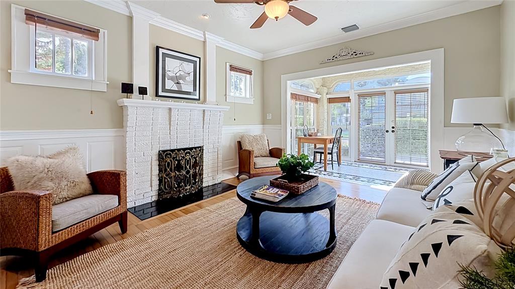 A living room features a white brick fireplace, wicker chairs, a sofa, and French doors — 1620 PARK LAKE STREET, ORLANDO, FL