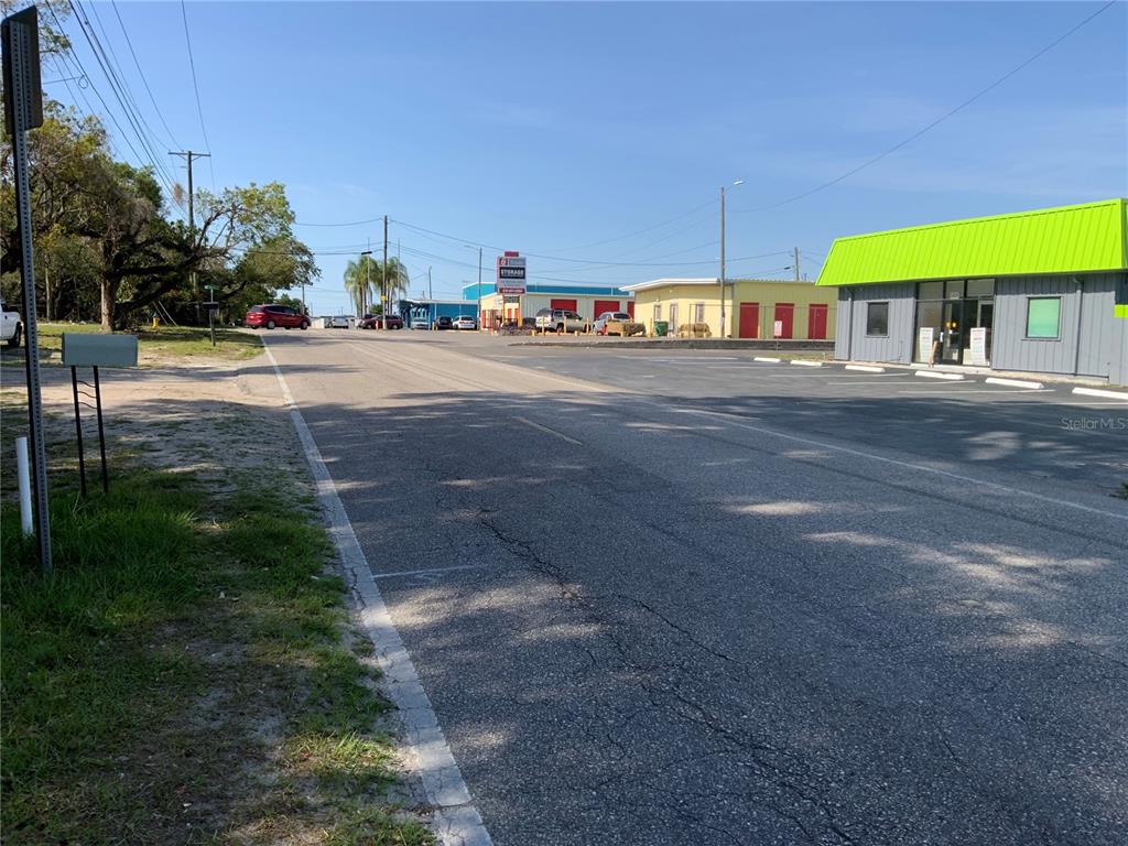 A street view shows a paved road leading toward several commercial buildings with parking lots — 5902 N 50TH STREET, TAMPA, FL