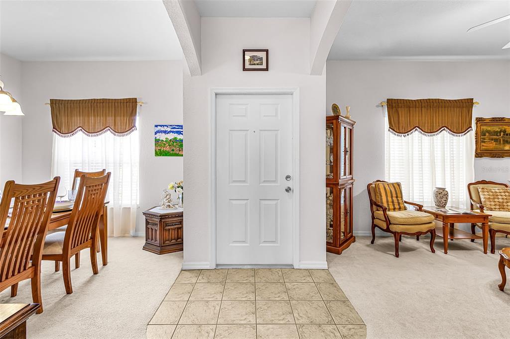 A tiled entryway leads to a dining area on the left and a living space — 2358 PILGER AVENUE, NORTH PORT, FL