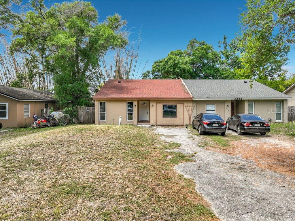 A single-story house with a two-tone exterior, a red roof, and a concrete driveway — 5214 2ND STREET, ORLANDO, FL