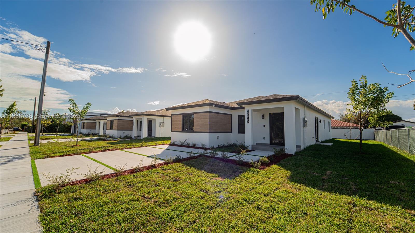 A row of modern, single-story houses with white stucco walls and wood-paneled accents — 22840 SW 122nd PL, Miami FL 33170, MIAMI, FL