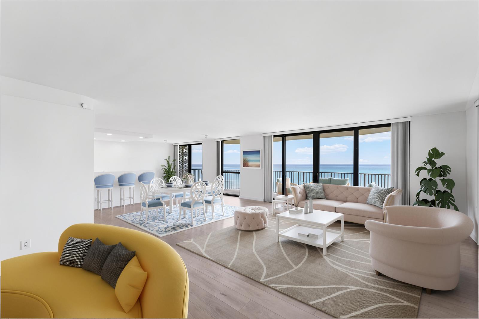 A bright, open-concept living and dining area features ocean views, light wood floors, and furniture — 3360 S Ocean Boulevard, Palm Beach FL 33480, PALM BEACH, FL