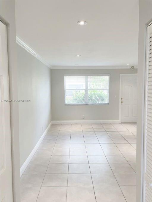 An empty room features light-colored tile flooring, recessed lighting, and a window with blinds — 500 NE 2nd St # 419, Dania Beach FL 33004, DANIA BEACH, FL