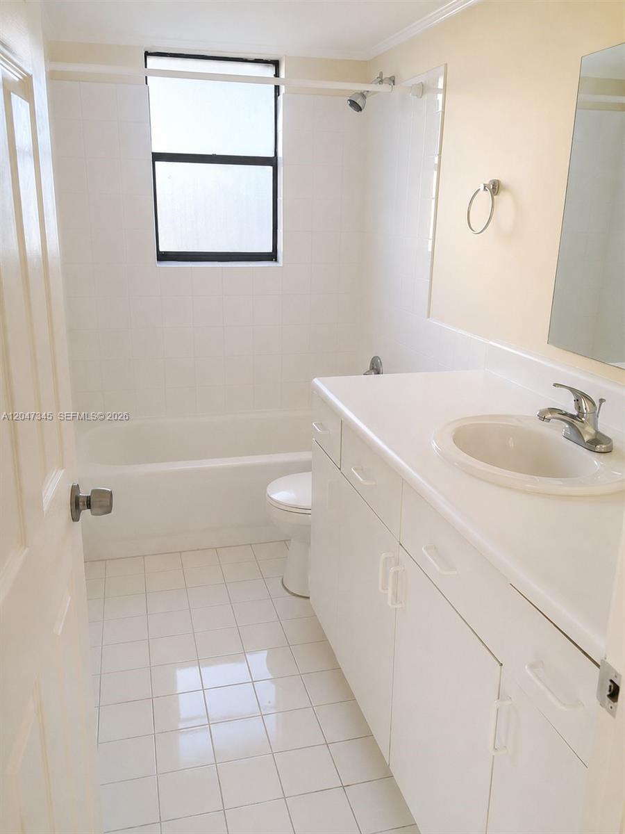 A bathroom features a white vanity, a tiled floor, and a tub-shower combination — 500 NE 2nd St # 419, Dania Beach FL 33004, DANIA BEACH, FL