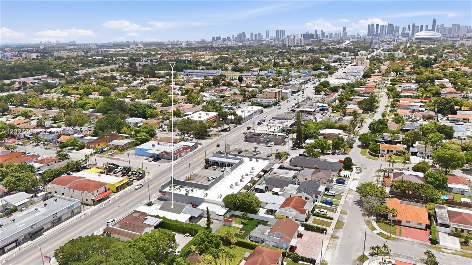 An aerial view shows a commercial building with a parking lot in a suburban neighborhood — 3240 NW 7th St, Miami FL 33125, MIAMI, FL