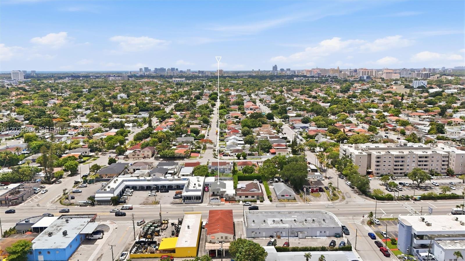 An aerial view shows a commercial and residential neighborhood with a street in the foreground — 3240 NW 7th St, Miami FL 33125, MIAMI, FL