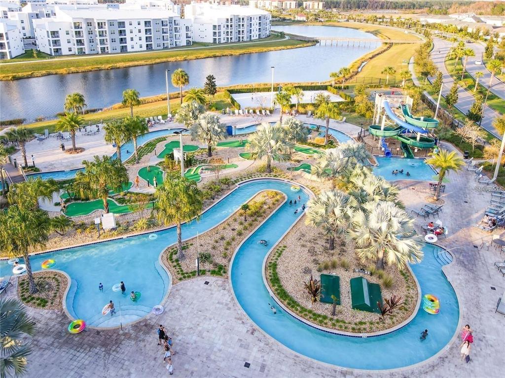 An aerial view of a resort pool area featuring a lazy river and water slide — 2790 OXYMORON WAY, KISSIMMEE, FL