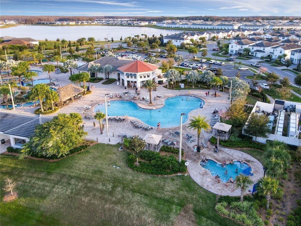 An aerial view of a community swimming pool complex with a clubhouse and surrounding homes — 2790 OXYMORON WAY, KISSIMMEE, FL