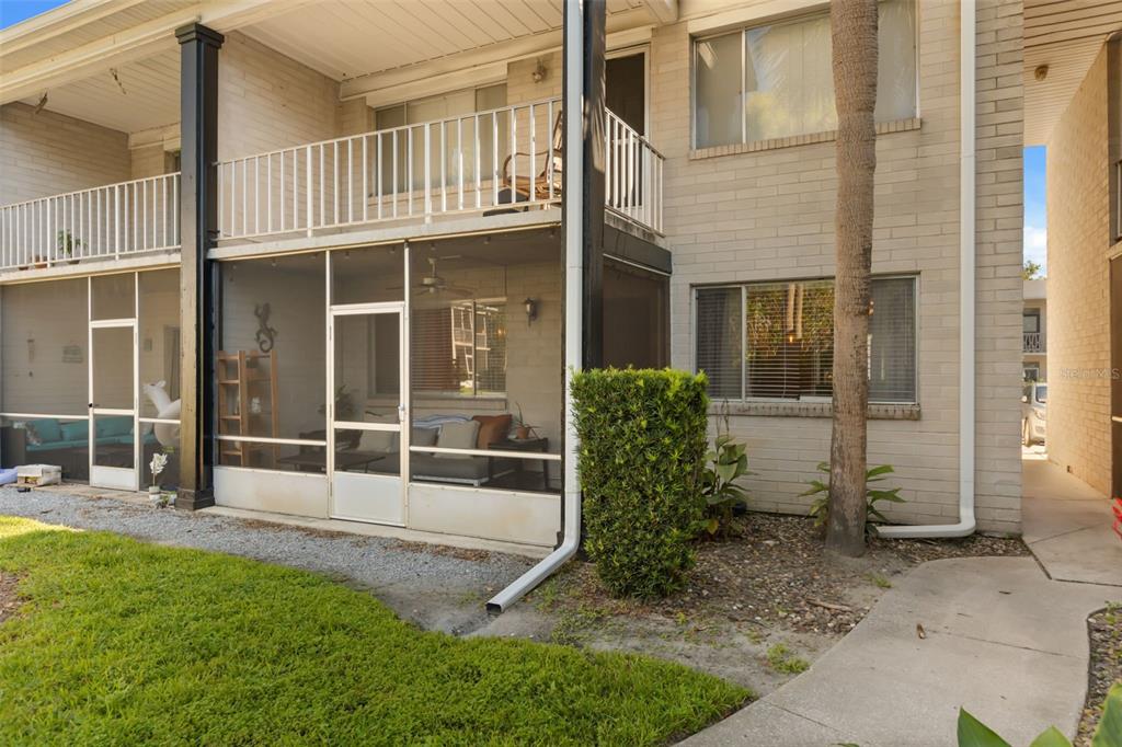 A two-story brick apartment building with a screened-in ground floor patio and an upper balcony — 1250 S DENNING DRIVE UNIT 109, WINTER PARK, FL