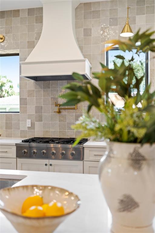 A kitchen features a white range hood, a gas cooktop, and a gold pot filler — 2925 OBERLIN AVENUE, ORLANDO, FL
