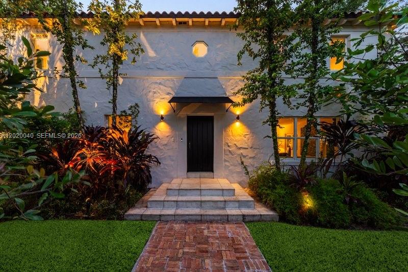 A two-story white stucco house features a black awning over the front entrance — 5812 Alton Rd, Miami Beach FL 33140, MIAMI BEACH, FL