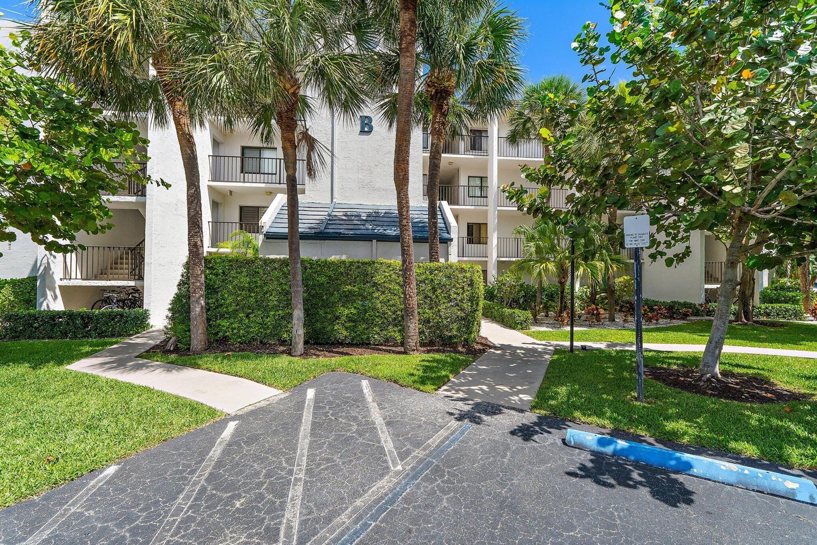 A multi-story residential building with palm trees, a hedge, and a parking space — 1605 S Us Highway 1 # B205, Jupiter FL 33477, JUPITER, FL
