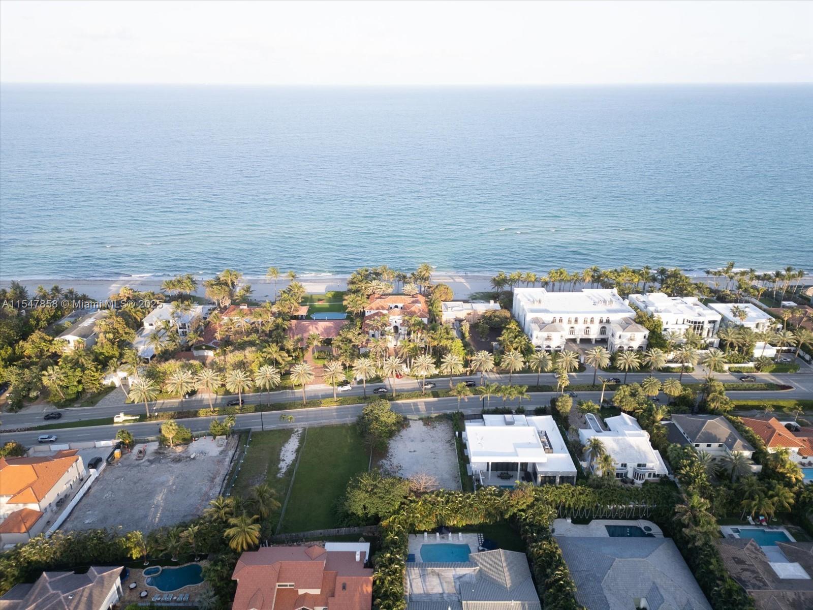An aerial view shows a coastal neighborhood with luxury homes, palm trees, and the ocean — 624 Ocean Blvd, Golden Beach FL 33160, GOLDEN BEACH, FL