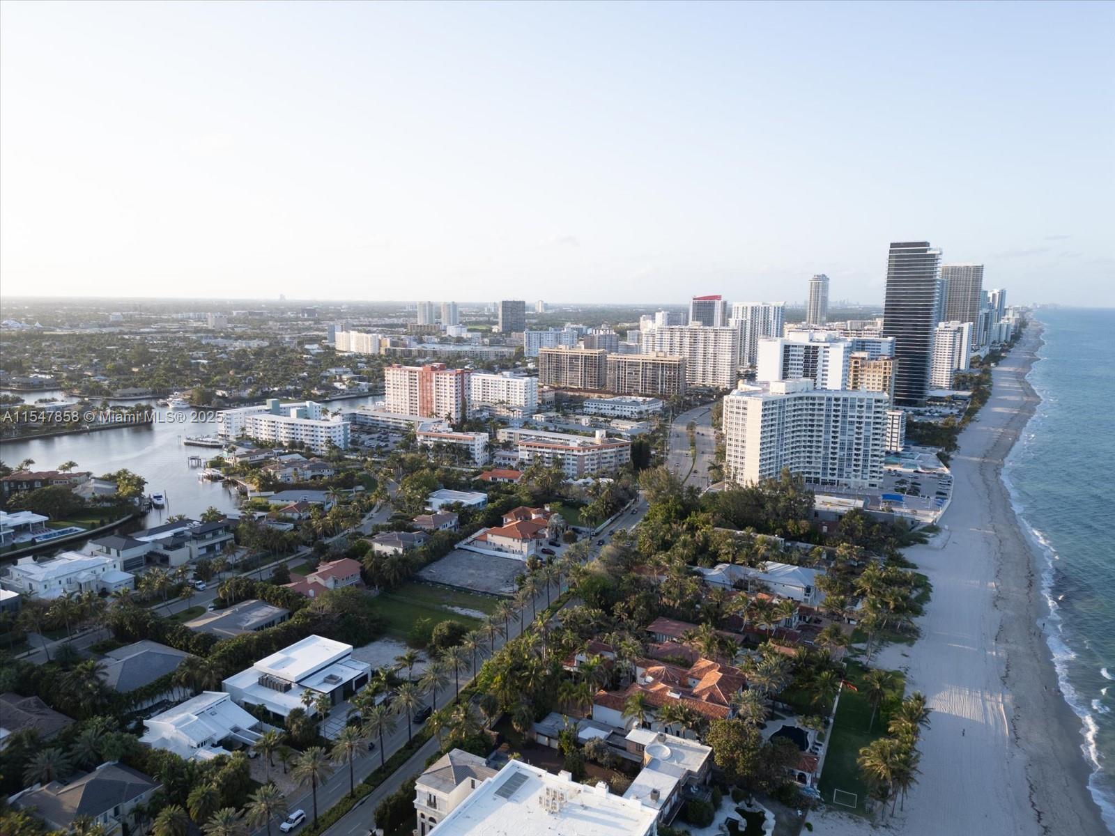 An aerial view shows a coastal city with high-rise buildings along a sandy beach — 624 Ocean Blvd, Golden Beach FL 33160, GOLDEN BEACH, FL