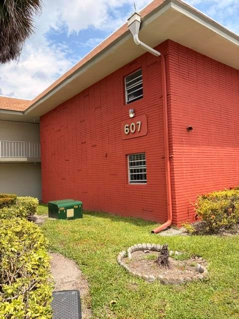 A two-story red brick building features a prominent address sign and a white downspout — 607 S State Rd 7 # 1g, Margate FL 33068, MARGATE, FL