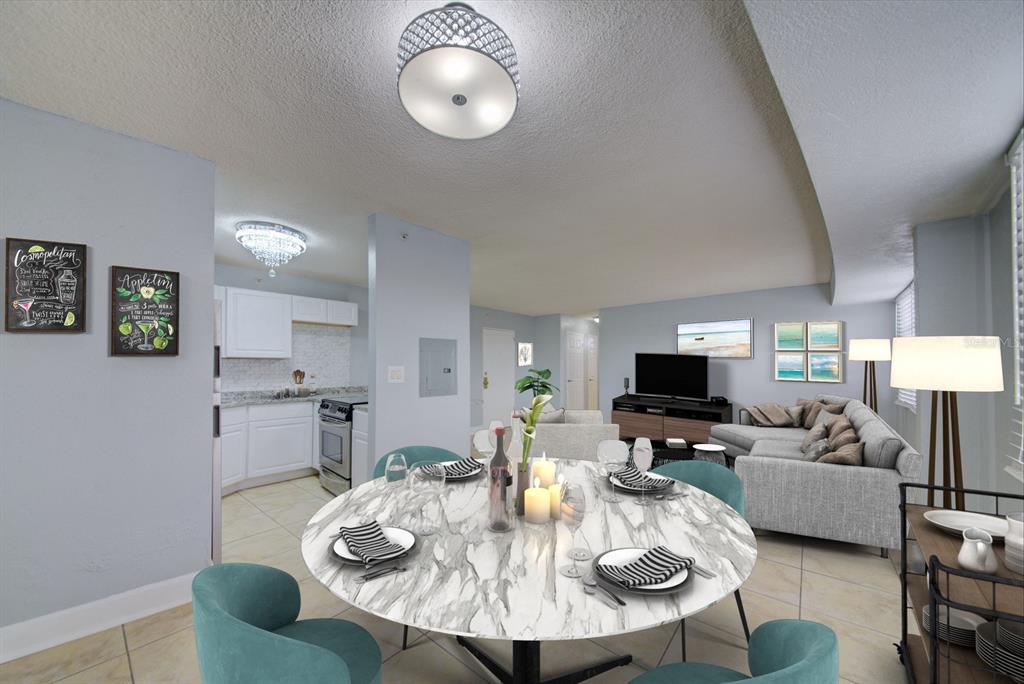 A dining area with a marble table and teal chairs opens into a living room — 3315 58TH AVENUE S UNIT 306, ST PETERSBURG, FL