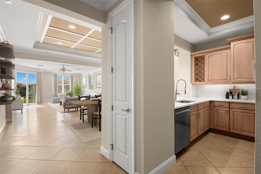 A view from a tiled hallway looking into a living area and a small kitchen — 8 ACADEMY WAY S UNIT 123, ST PETERSBURG, FL
