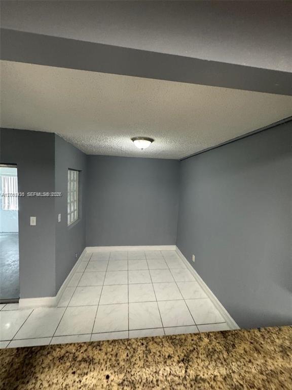 A dining area with gray walls, white tile flooring, and a central ceiling light fixture — 5955 NW 25th Ct # 208, Sunrise FL 33313, SUNRISE, FL