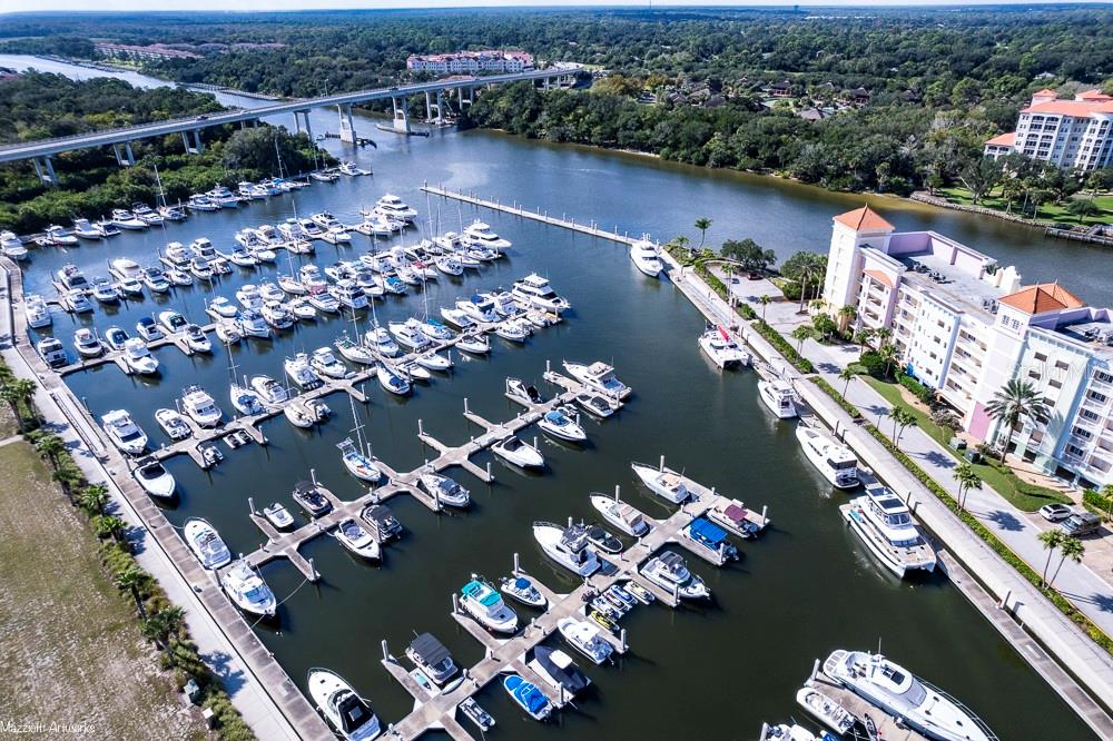 An aerial view shows a marina filled with boats next to a large apartment complex — 102 YACHT HARBOR DRIVE UNIT 263, PALM COAST, FL