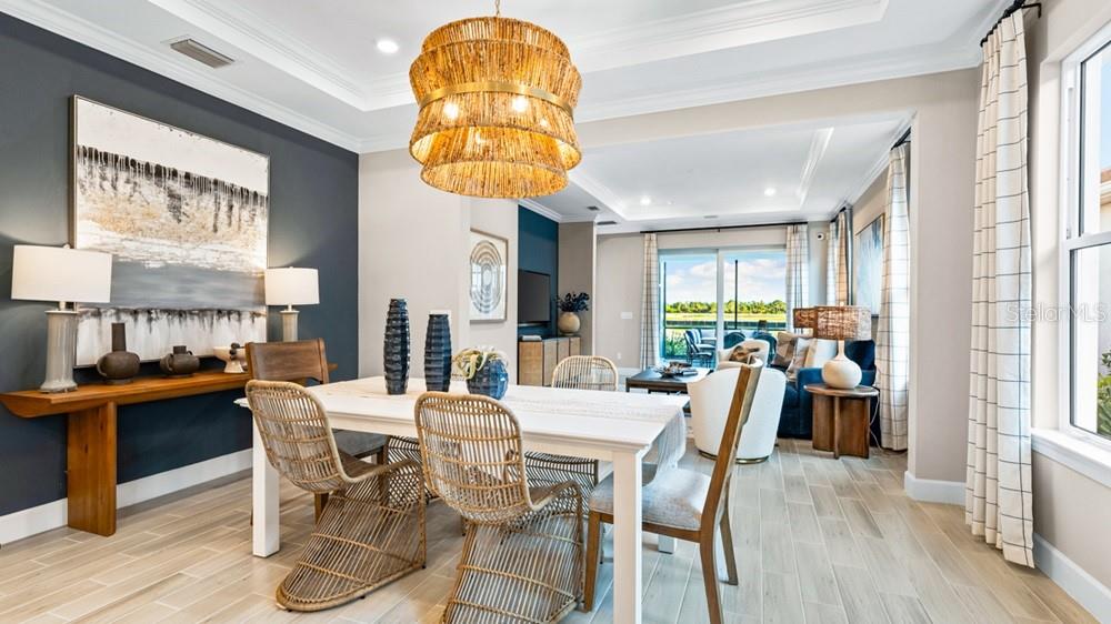 A bedroom features a patterned accent wall, a wooden bed frame, and large windows — 26937 LARK COURT, PUNTA GORDA, FL