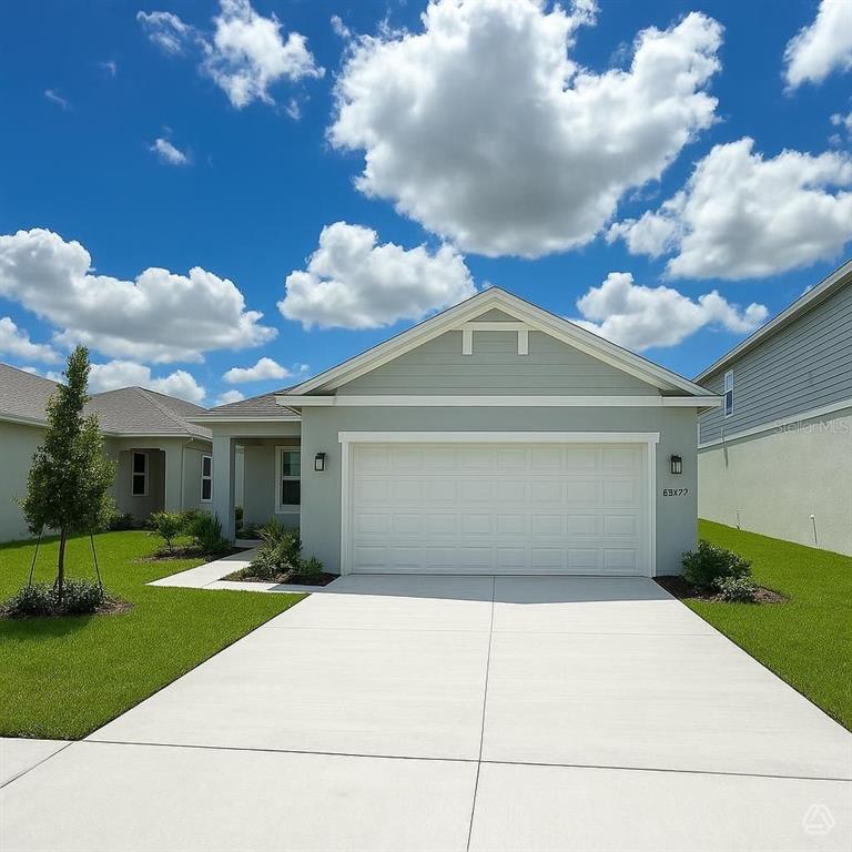 A light green, single-story suburban house with a two-car garage and a concrete driveway — 13020 SASSAFRAS TRAIL, PARRISH, FL