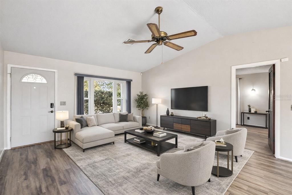 A living room features a sectional sofa, two armchairs, a television, and a ceiling fan — 501 ANTOINETTE STREET, DELTONA, FL