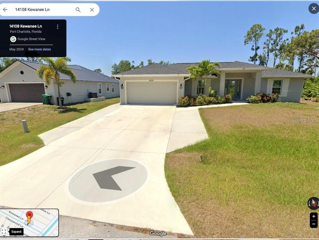 A single-story suburban house with a two-car garage and a concrete driveway — 14108 KEWANEE LANE, PORT CHARLOTTE, FL