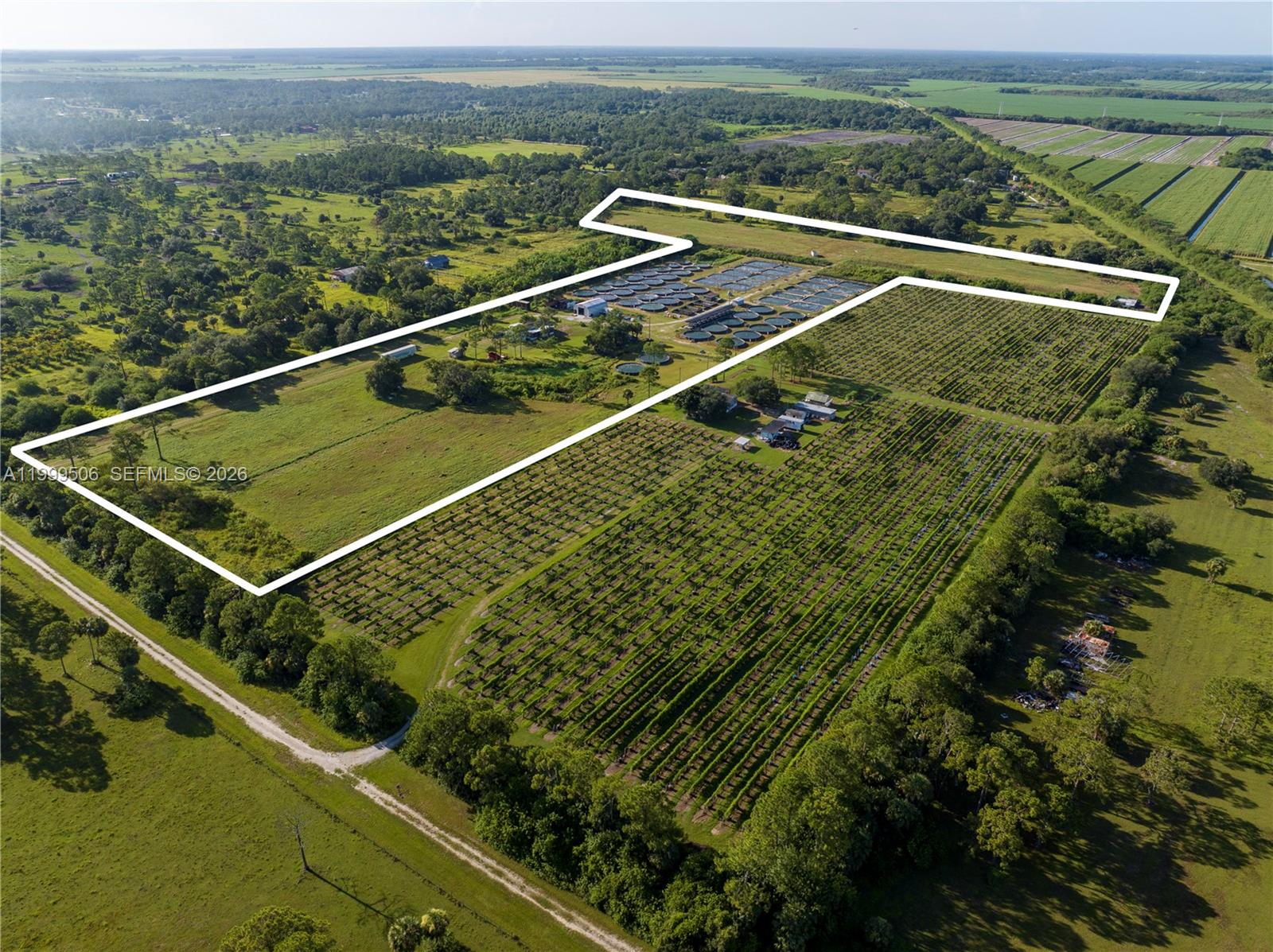 An aerial view shows a large rural property with agricultural fields, circular ponds, and buildings — 14759 Center Ave, Clewiston FL 33440, CLEWISTON, FL