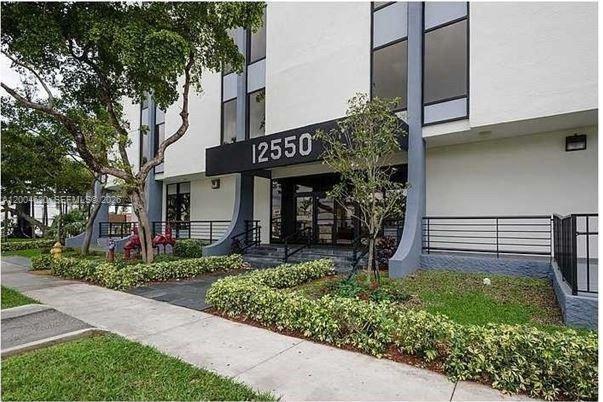 The exterior of a multi-story building features a prominent entrance with the number 12550 displayed — 12550 Biscayne Blvd UNIT 403, North Miami FL 33181, NORTH MIAMI, FL