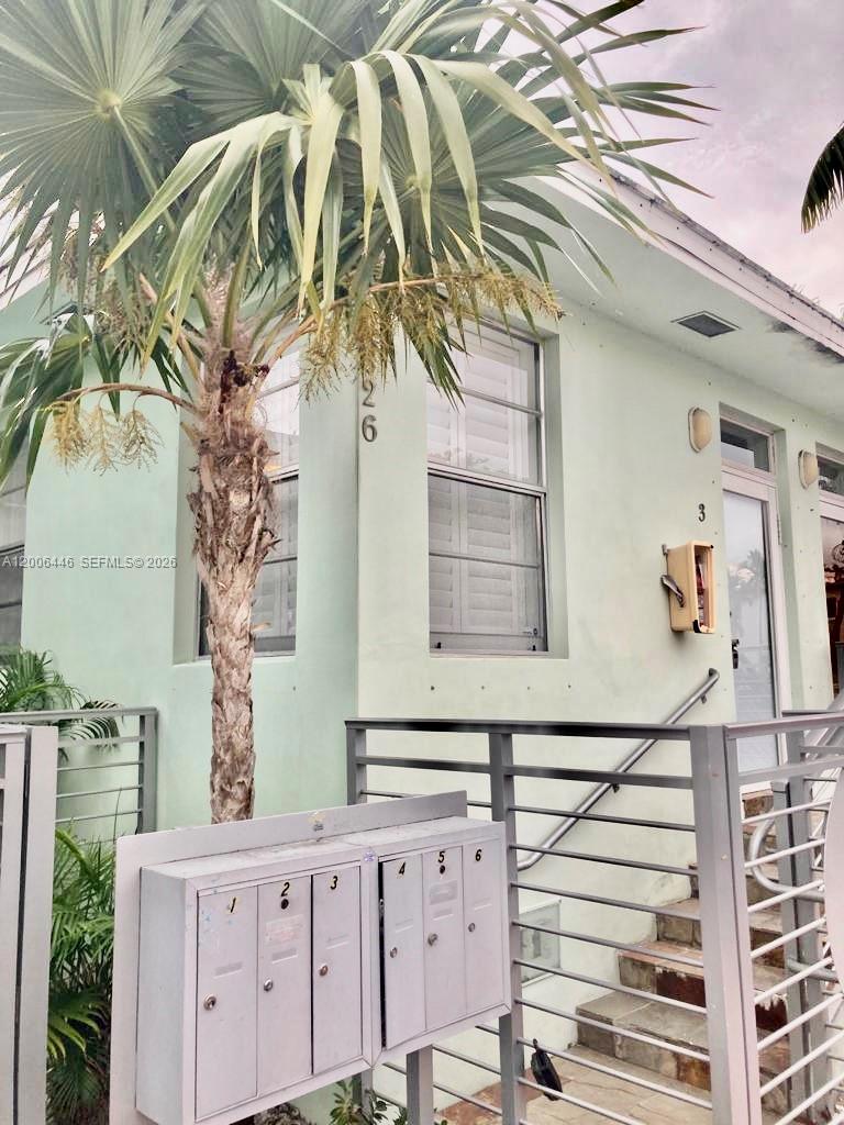A light green building exterior features a palm tree and a row of metal mailboxes — 826 7th St # 3, Miami Beach FL 33139, MIAMI BEACH, FL