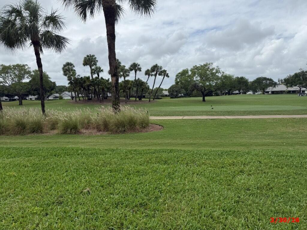 A view of a golf course fairway with palm trees and houses in the distance — 9 Windsor Lane, Boynton Beach FL 33436, BOYNTON BEACH, FL