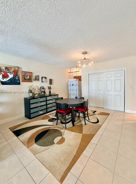 A dining area features a round table with four chairs on a patterned area rug — 3901 S Ocean Dr # 7M, Hollywood FL 33019, HOLLYWOOD, FL