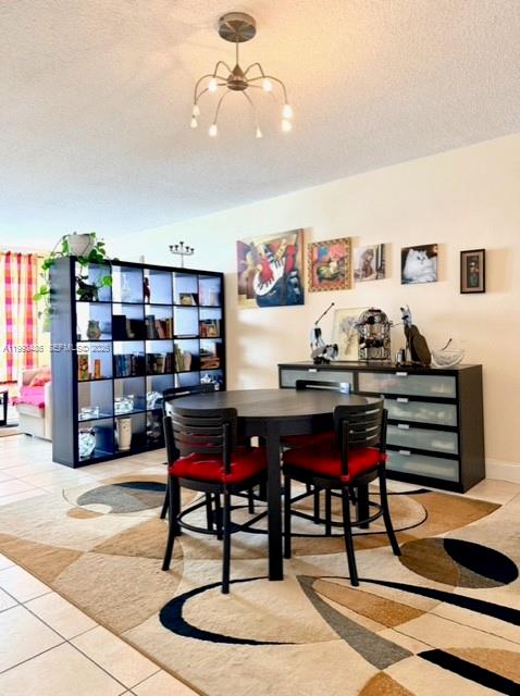 A dining area features a round table with four chairs on a patterned area rug — 3901 S Ocean Dr # 7M, Hollywood FL 33019, HOLLYWOOD, FL