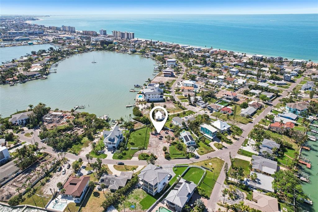 An aerial view shows a coastal neighborhood with a vacant lot marked by a pin — 15825 REDINGTON DRIVE, REDINGTON BEACH, FL