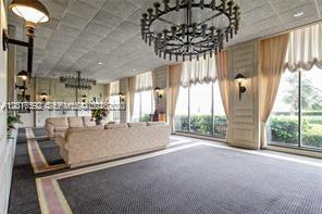 A spacious room features a large sofa, a chandelier, and floor-to-ceiling windows with curtains — 5555 Collins Ave # 14U, Miami Beach FL 33140, MIAMI BEACH, FL