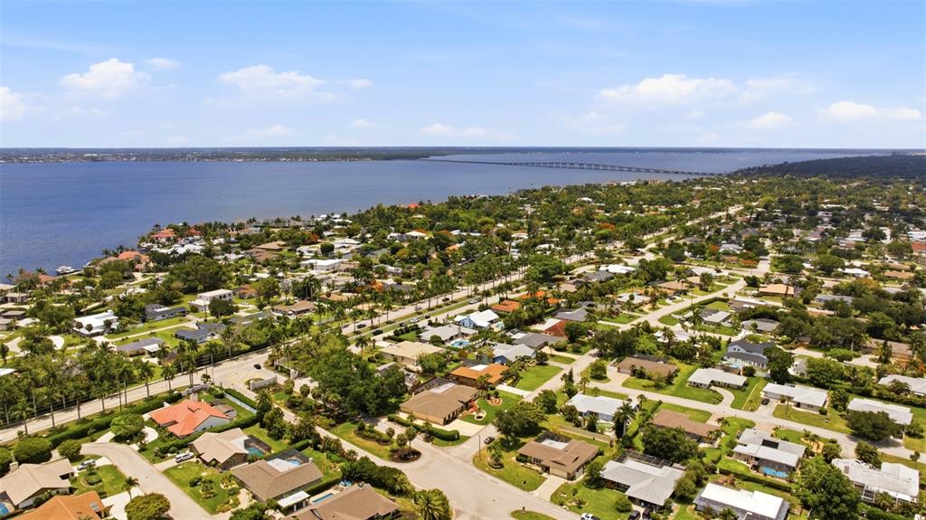 An aerial view of a residential neighborhood situated along a large body of water — 1335 WHISKEY CREEK DRIVE, FORT MYERS, FL