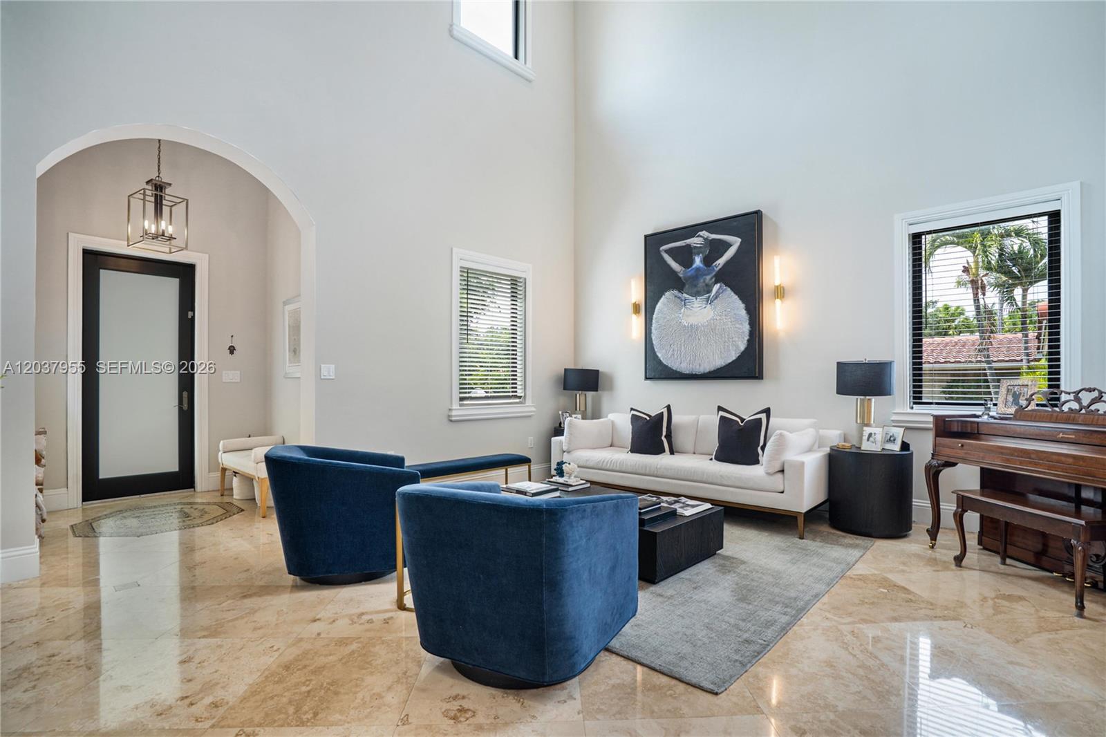 A living room features high ceilings, marble floors, blue armchairs, and a white sofa — 8919 NE 10th Ave, Miami FL 33138, MIAMI, FL