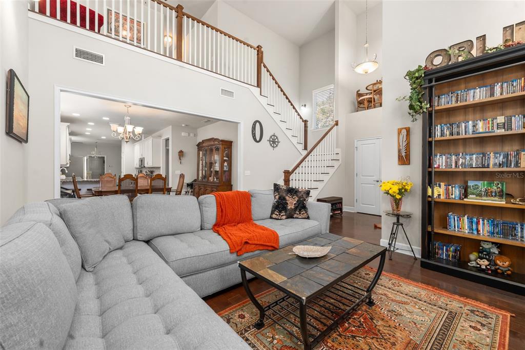 A kitchen with white cabinets, granite countertops, stainless steel appliances, and hardwood floors — 8317 SW 78TH LANE, GAINESVILLE, FL